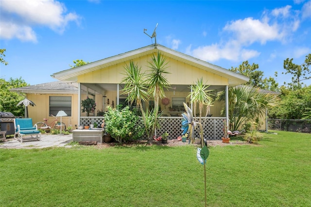 back of property with a patio and a lawn