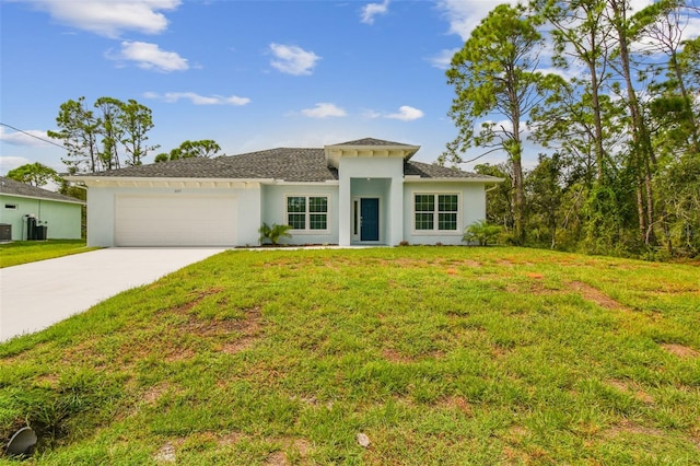 mediterranean / spanish-style home with a garage and a front lawn