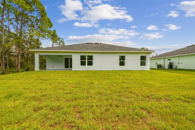 back of house with cooling unit, a lawn, a patio, and ceiling fan