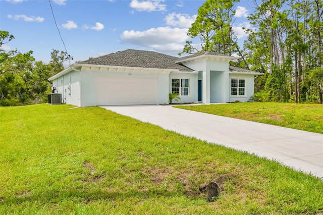 view of front facade with a garage, a front yard, and central air condition unit