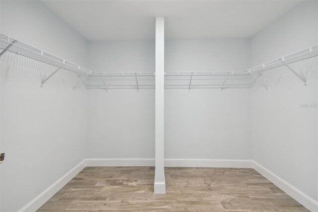 spacious closet with light hardwood / wood-style flooring