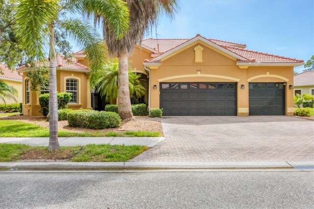 mediterranean / spanish home with a garage