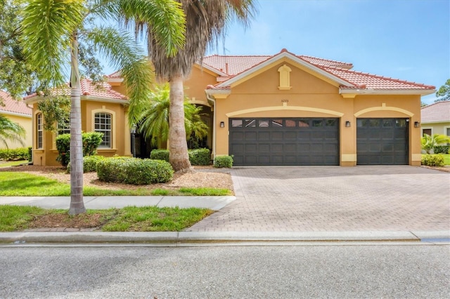 mediterranean / spanish home with a garage