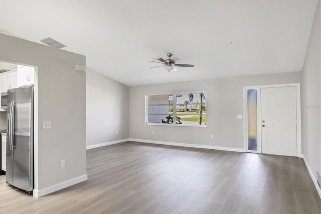 unfurnished living room featuring a ceiling fan, baseboards, visible vents, and light wood finished floors