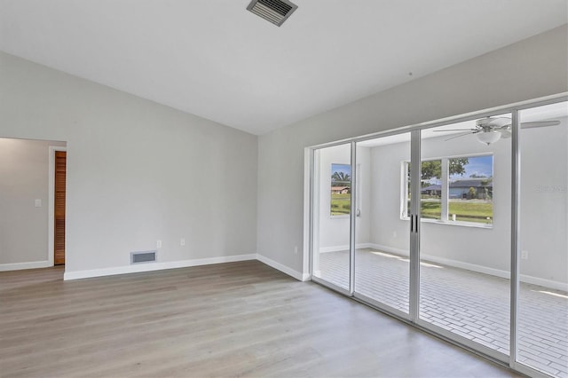 unfurnished room with baseboards, visible vents, and light wood finished floors