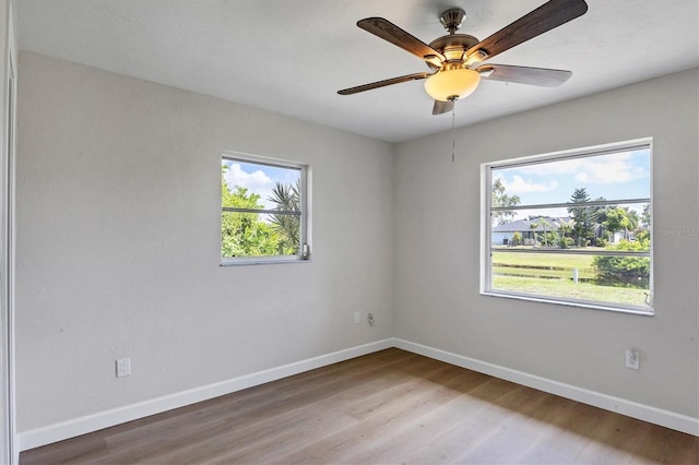 empty room featuring baseboards and wood finished floors