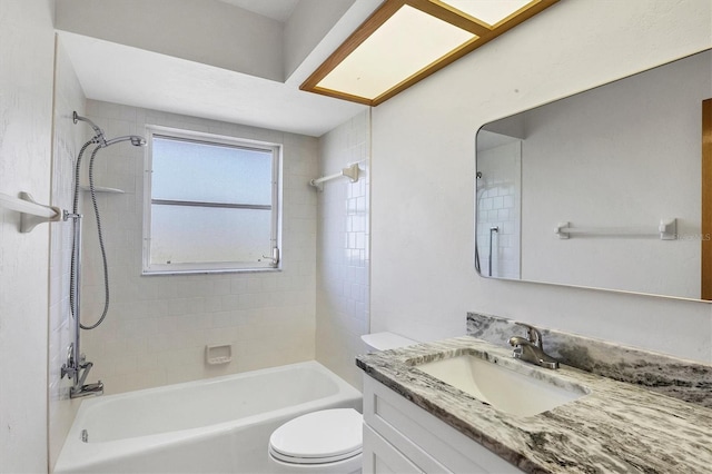 bathroom with bathtub / shower combination, vanity, and toilet