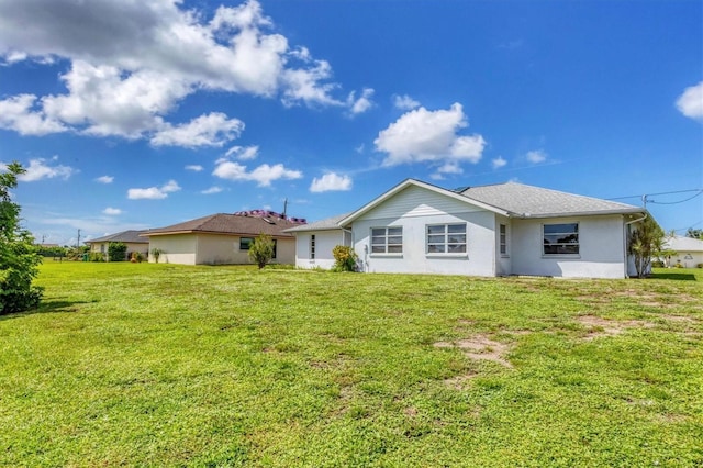 back of property featuring a lawn