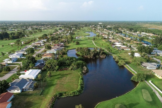 bird's eye view featuring golf course view, a water view, and a residential view