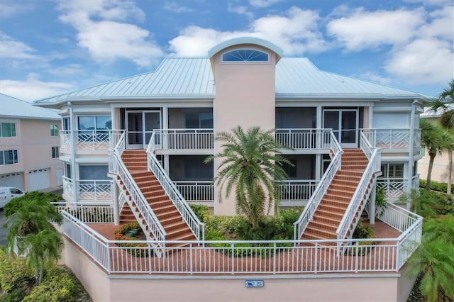 view of building exterior featuring a garage and stairway