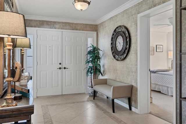 foyer featuring ornamental molding, light tile patterned flooring, baseboards, and a ceiling fan