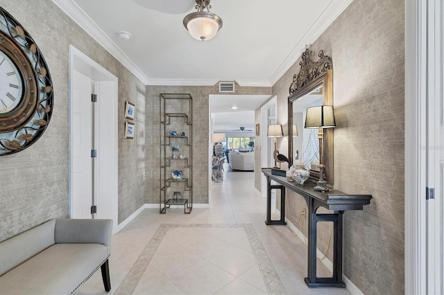 entrance foyer with ornamental molding, visible vents, baseboards, and light tile patterned floors