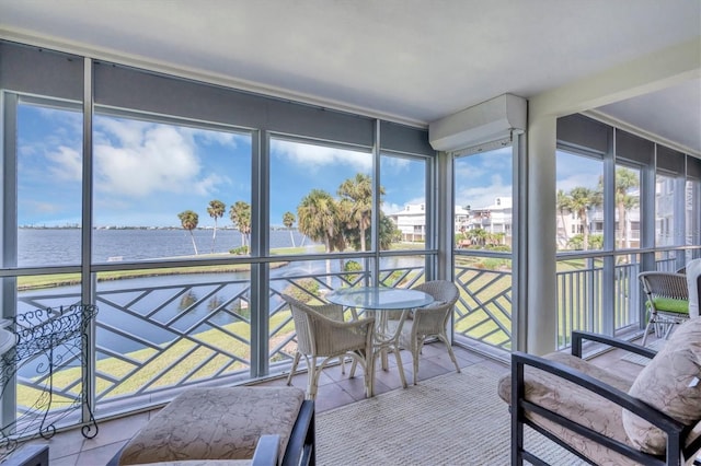 unfurnished sunroom featuring a wealth of natural light and a water view