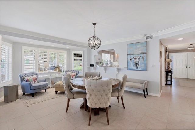 dining space with a chandelier, light tile patterned floors, a wealth of natural light, and ornamental molding