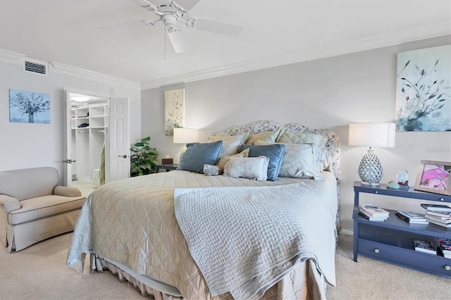 bedroom featuring carpet floors, visible vents, a spacious closet, ornamental molding, and ceiling fan