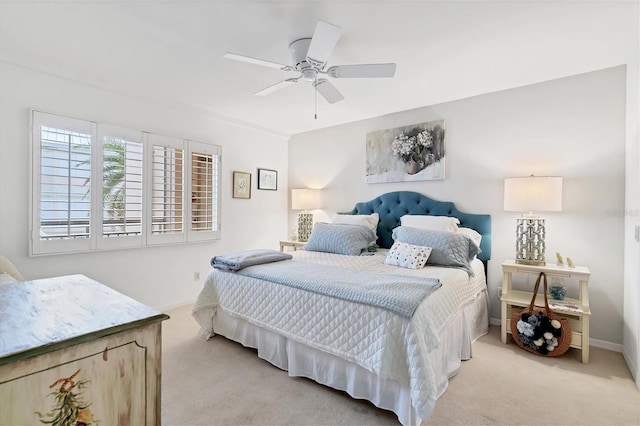 bedroom with baseboards, ceiling fan, and light colored carpet