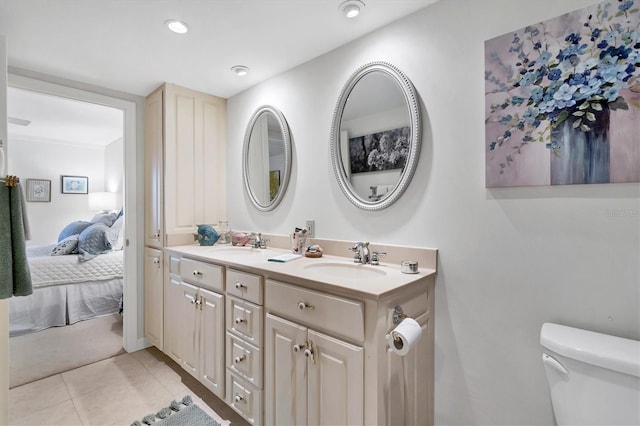 full bathroom featuring toilet, tile patterned floors, a sink, and ensuite bathroom