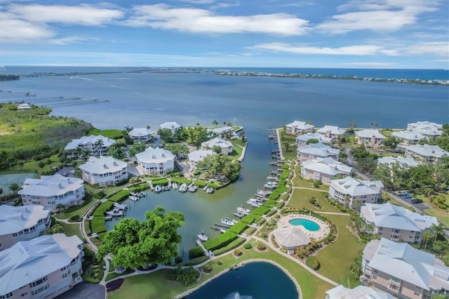 birds eye view of property with a water view and a residential view