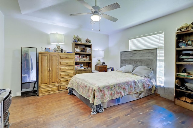 bedroom with hardwood / wood-style flooring and ceiling fan