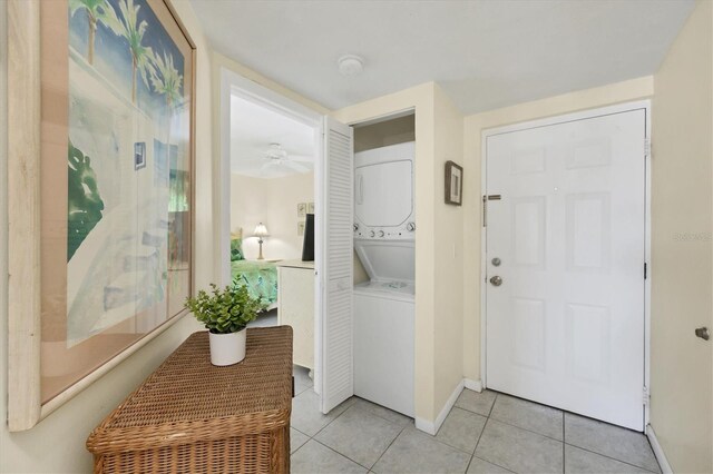 7070 Placida Rd Unit 1221, Placida, FL 33946 - laundry room featuring stacked washer and clothes dryer, light tile patterned floors, baseboards, and ceiling fan