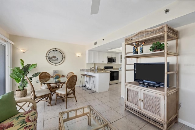 living room featuring light tile patterned flooring and sink