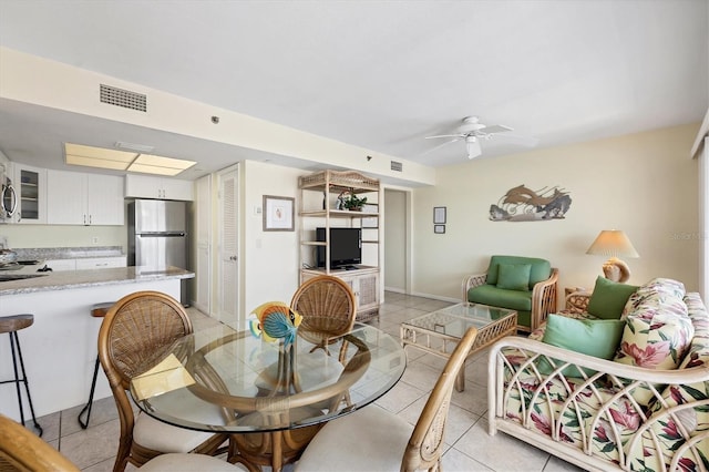 living room featuring light tile patterned floors and ceiling fan