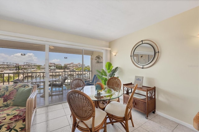 7070 Placida Rd Unit 1221, Placida, FL 33946 - dining room featuring light tile patterned floors, baseboards, and a water view