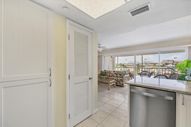 7070 Placida Rd Unit 1221, Placida, FL 33946 - kitchen with dishwasher, light tile patterned floors, and light stone counters