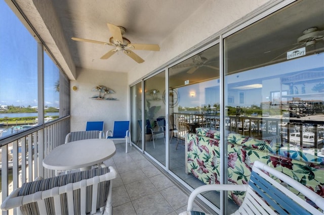 sunroom featuring ceiling fan and plenty of natural light