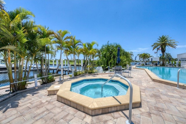 view of swimming pool with a patio and a community hot tub