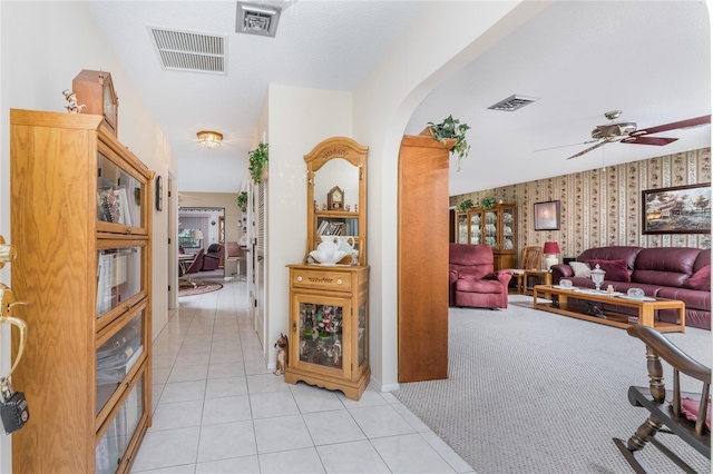 hall featuring light tile patterned floors