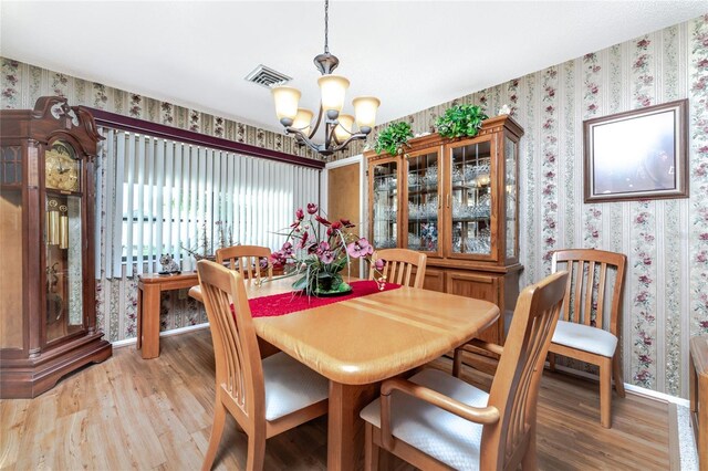 dining area with a notable chandelier and wood-type flooring