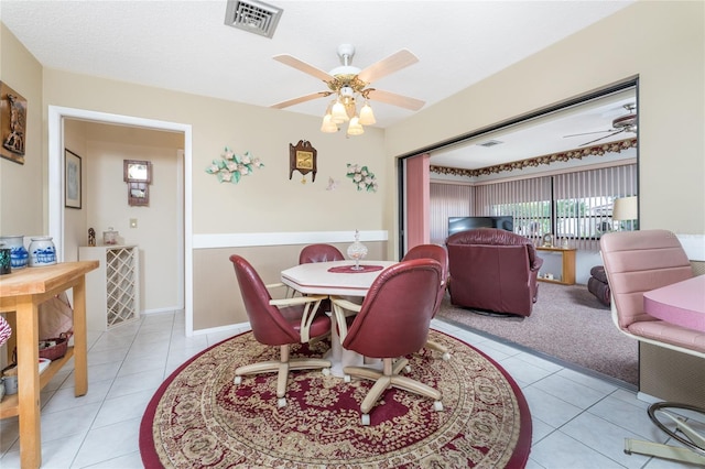 dining room featuring light tile patterned floors, visible vents, and a ceiling fan