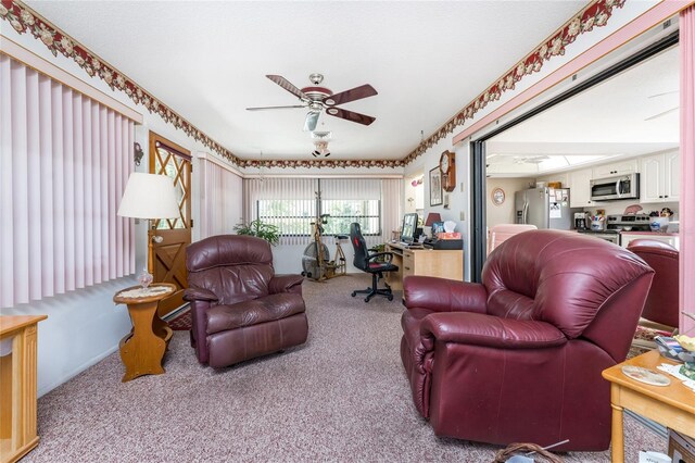 carpeted living room featuring ceiling fan