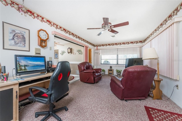 carpeted office space featuring ceiling fan