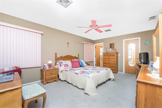 bedroom featuring ceiling fan, visible vents, and light colored carpet