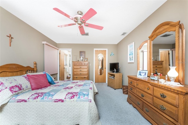 bedroom with light carpet, ceiling fan, and visible vents