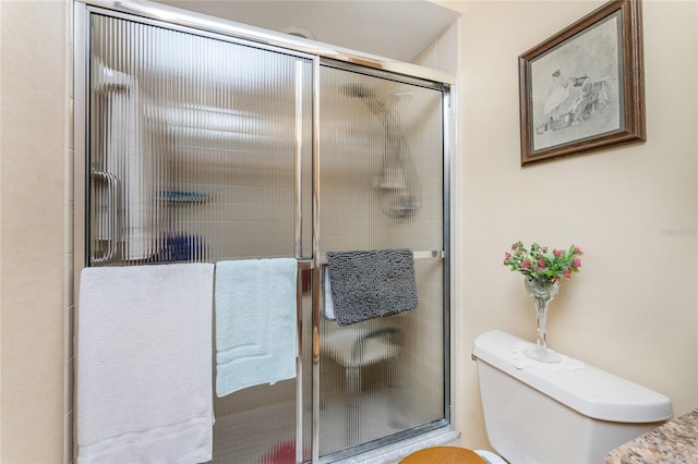 bathroom featuring toilet and walk in shower