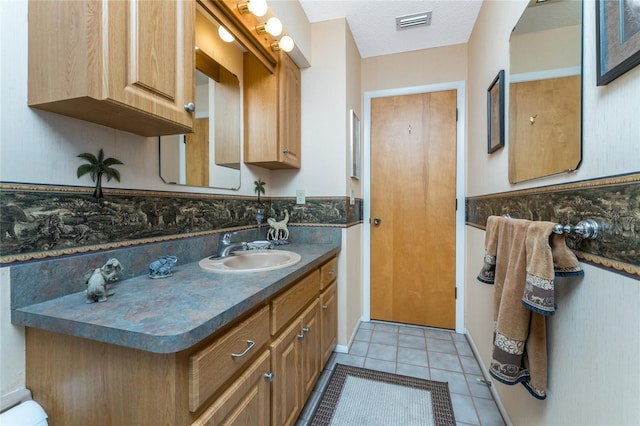 bathroom featuring vanity, visible vents, and tile patterned floors