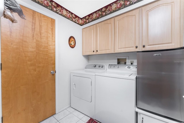 laundry room featuring light tile patterned flooring, independent washer and dryer, and cabinet space