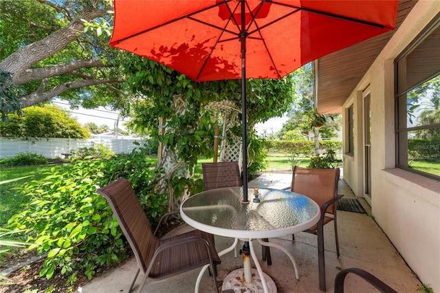 view of patio with fence and outdoor dining area