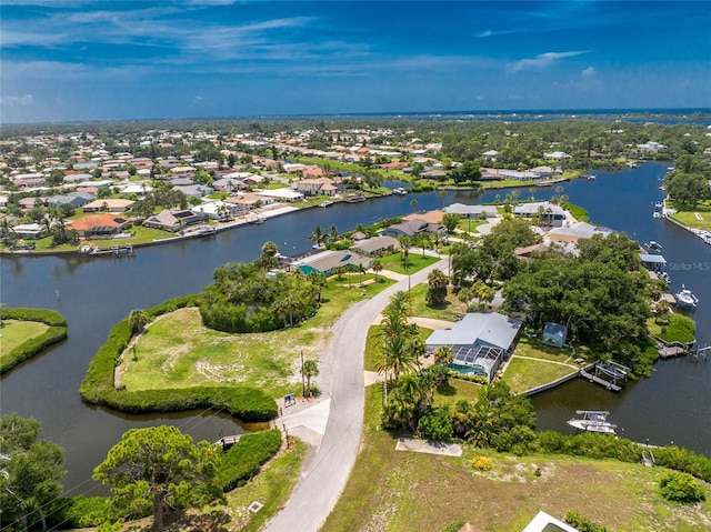 drone / aerial view with a water view and a residential view