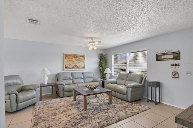 living room with light tile patterned flooring, a textured ceiling, and ceiling fan