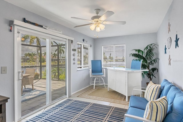 home office featuring light tile patterned floors and ceiling fan