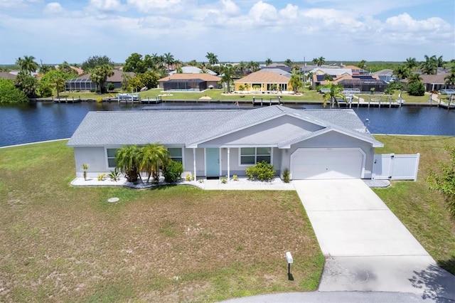 ranch-style house featuring a water view, a garage, and a front yard