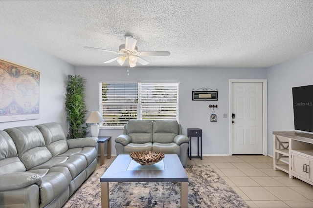 living room with light tile patterned floors, a textured ceiling, and ceiling fan