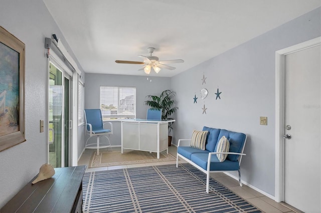 sitting room featuring ceiling fan and tile patterned floors