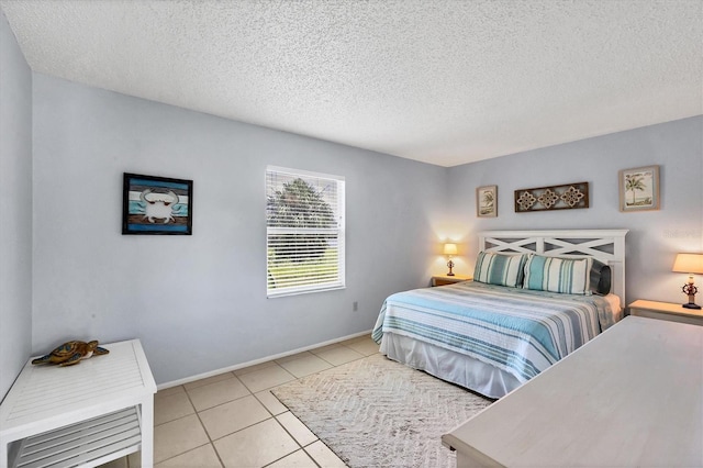 bedroom featuring a textured ceiling and light tile patterned floors