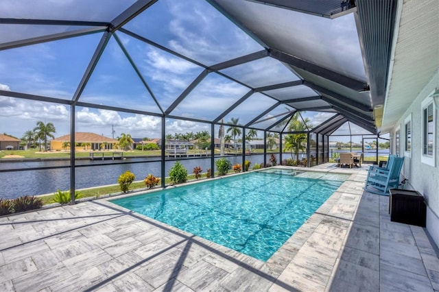 view of swimming pool featuring a water view, a patio, and glass enclosure