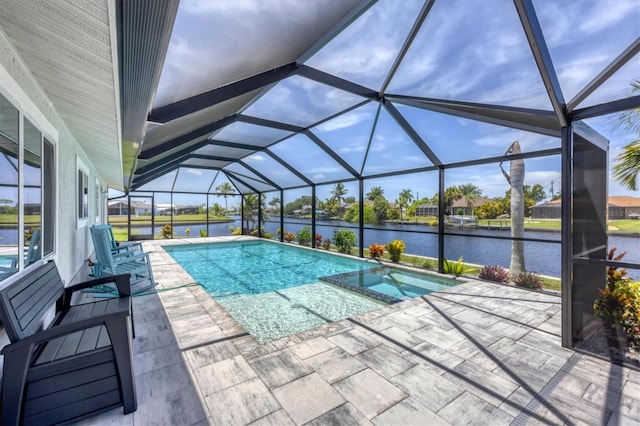 view of pool featuring a patio, a water view, and a lanai